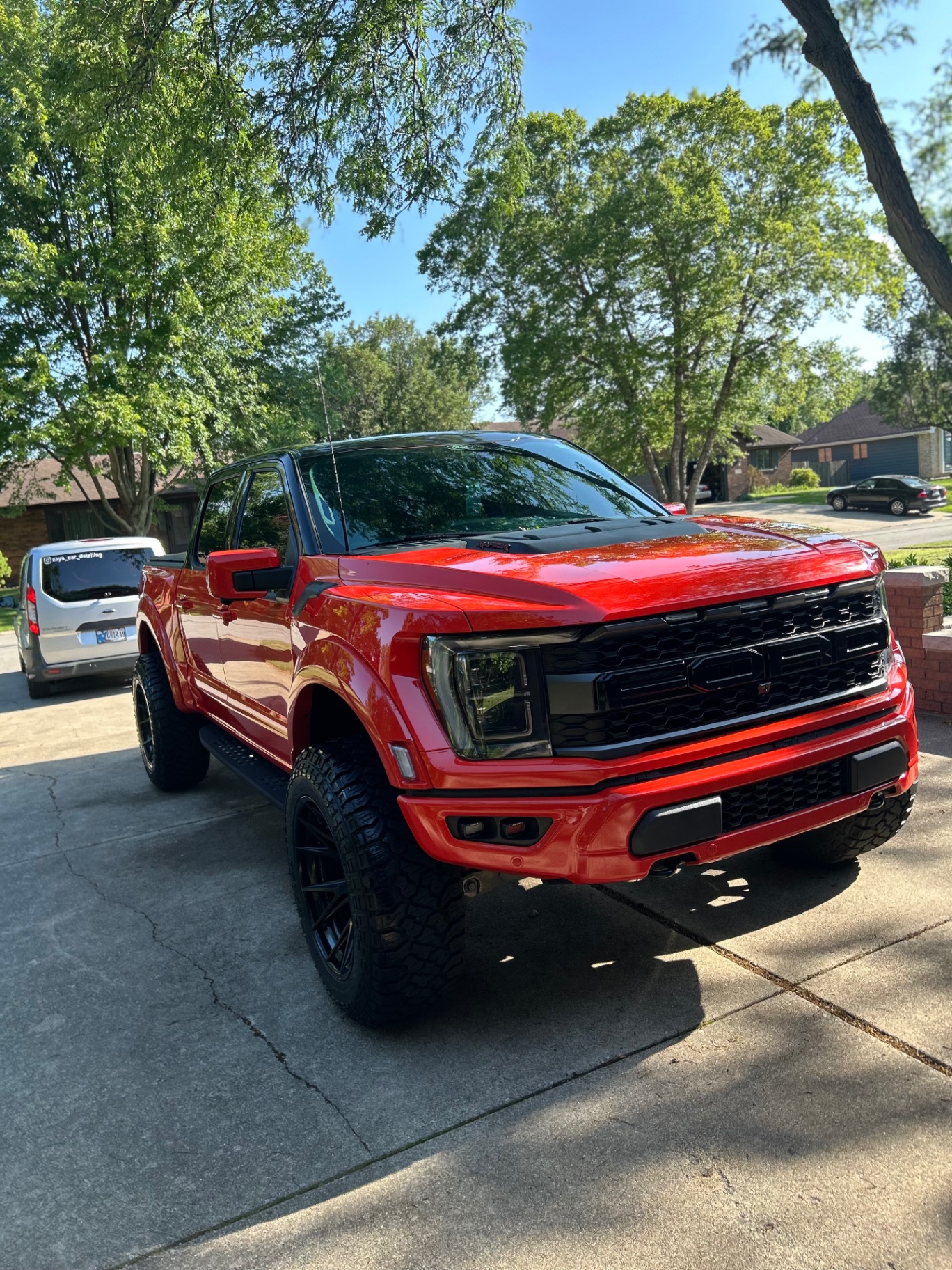 Red lifted Ford truck after exterior detail and shine enhancement