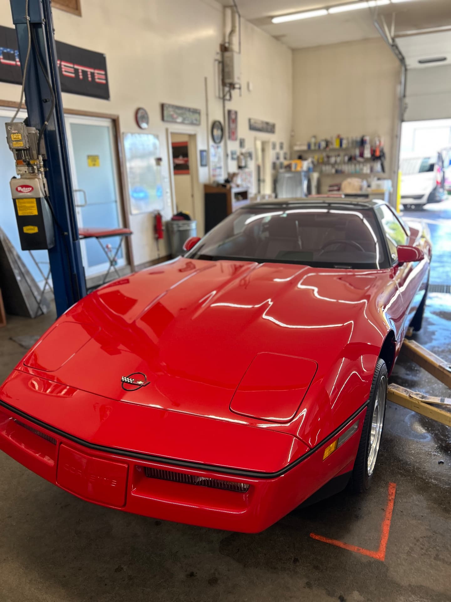 Red Corvette with reflective paint in the garage